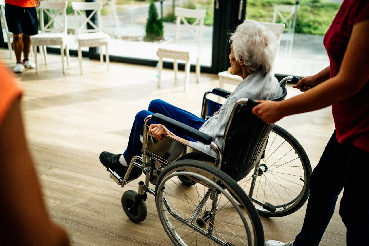 why-choose-us A caregiver assists a senior adult in a wheelchair at a nursing home in Prague, Czech Republic.